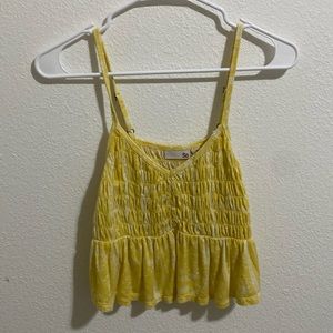 A yellow SO crop top with readjust straps